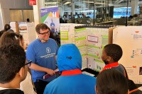 Dr. Grady Nelson interviews a student scientist at the science fair. 