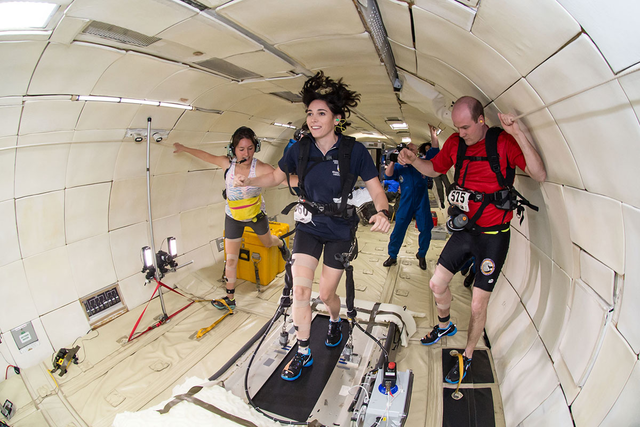 Three people in weightless environment.